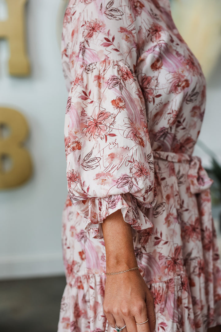 A closeup of the 3/4 bubble sleeve on a pink floral dress.