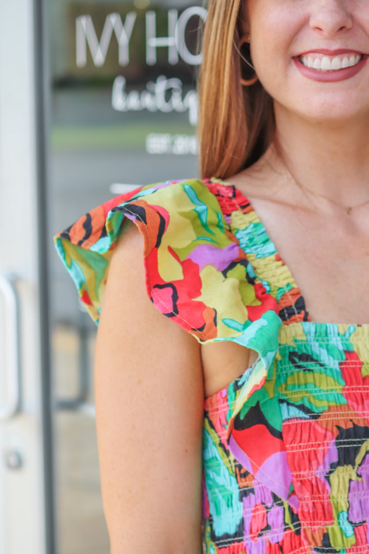 A closeup of the colors and ruffle shoulder on a smocked top.